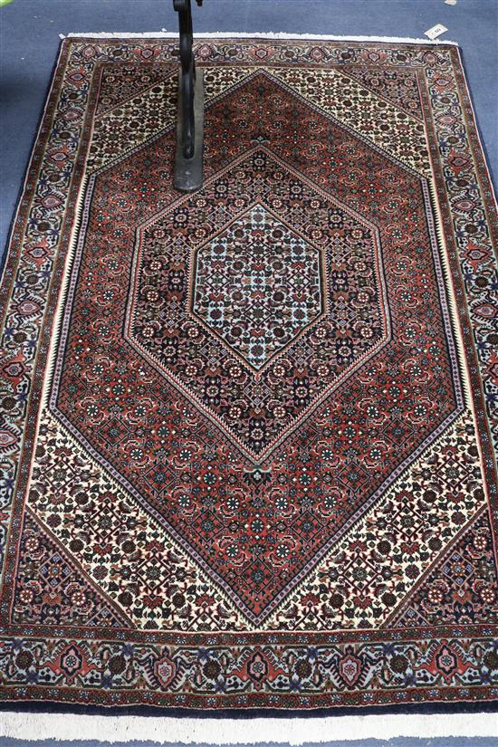 A Persian blue ground rug with central lozenge 165 x 110cm